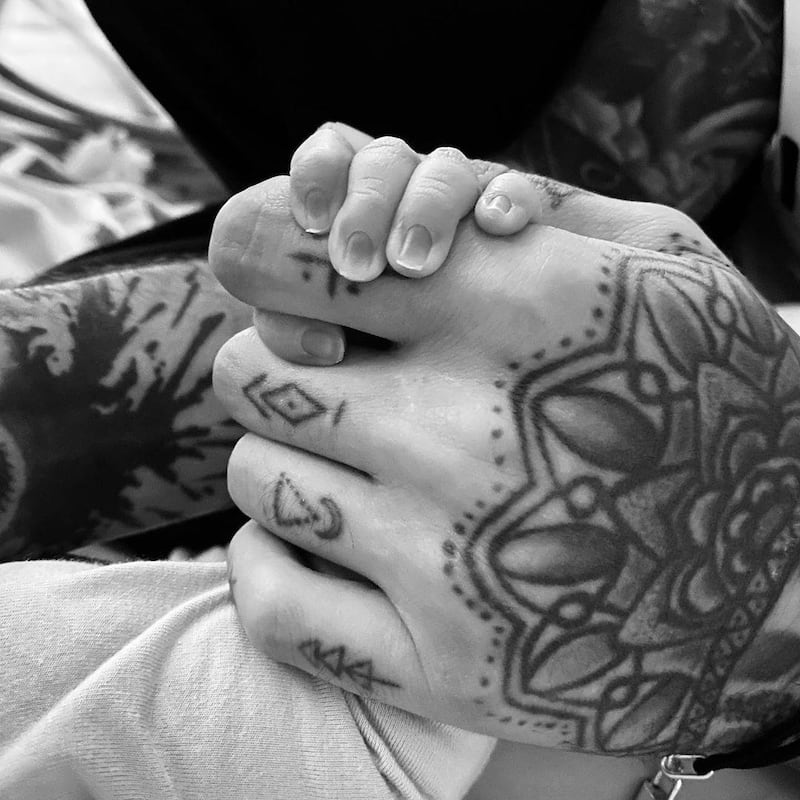 Former One Direction singer Zayn Malik shared this photo of his hand with his baby girl's to announce her birth. Instagram / Zayn Malik 
