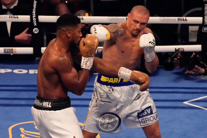 Oleksandr Usyk throws a punch at Anthony Joshua. AP