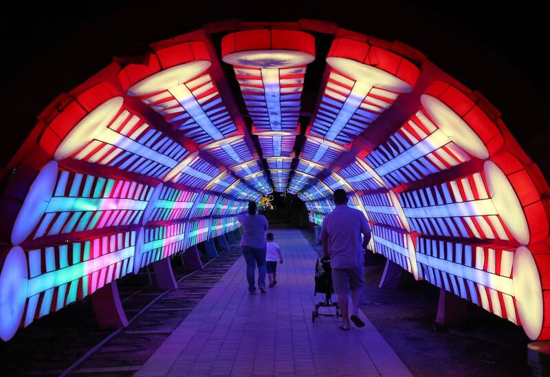 DUBAI, UNITED ARAB EMIRATES , October 14 – 2020 :- View of the colourful light tunnel at the Dubai Garden Glow season 6 which opened on 12th October at the Zabeel park in Dubai. No sitting allowed on the benches as a precautionary measure against the spread of coronavirus. Security at the entrance gate checks the body temperature of all the visitors. (Pawan Singh / The National) For Life Style/Online/Instagram/Big Picture. Story by Evelyn Lau