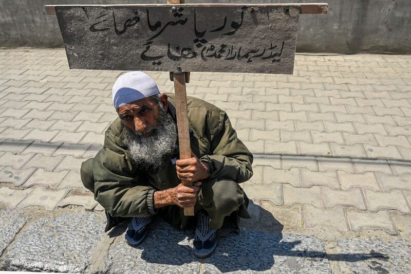 A man holds a placard during a protest in Srinagar. AFP
