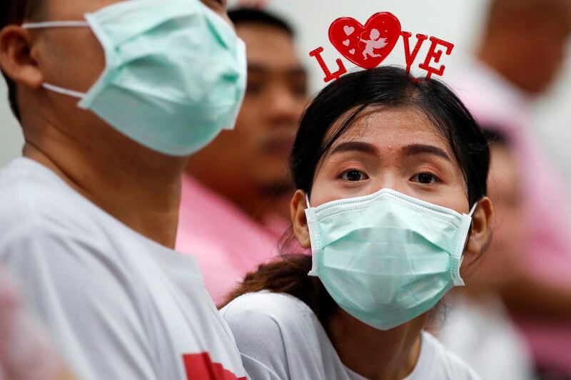 A soon-to-be-married couple wear protective masks at a marriage registry in Bangkok, Thailand. EPA