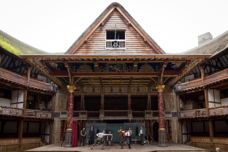 Members of the cast of a touring production of William Shakespeare’s “Hamlet” perform during a photocall at the Globe theatre in London in 2014. The theatre has been a major tourism attraction since it opened in 1997. AFP Photo/Leon Neal 