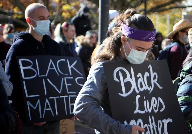 Demonstrators observe a minute's silence in Canberra, Australia on Friday, June 5, 2020 in memory of deaths in custody including George Floyd. AP Photo