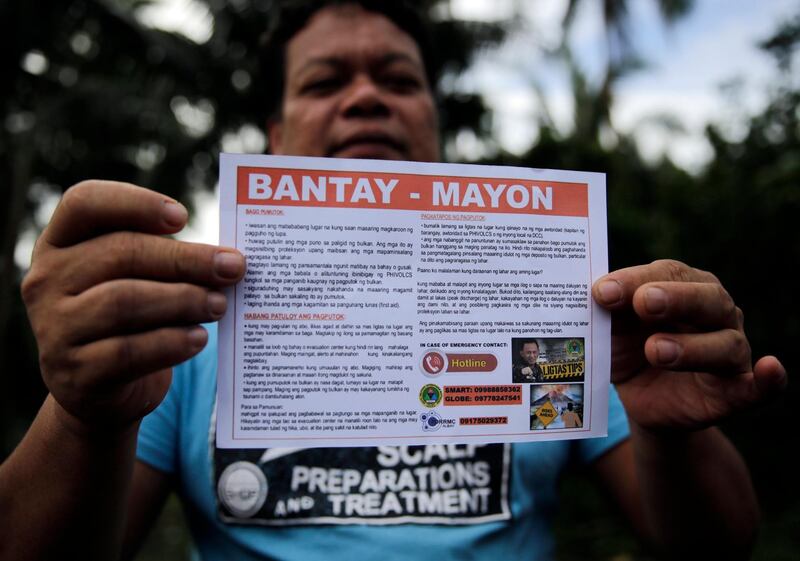 A Filipino villager living along the slopes of rumbling Mayon Volcano displays a notice to vacate in Legaspi city, Philippines. Francis R. Malasig / EPA