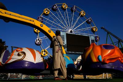A Taliban fighter stands guard in an amusement park in Kabul, Afghanistan, in November. AP