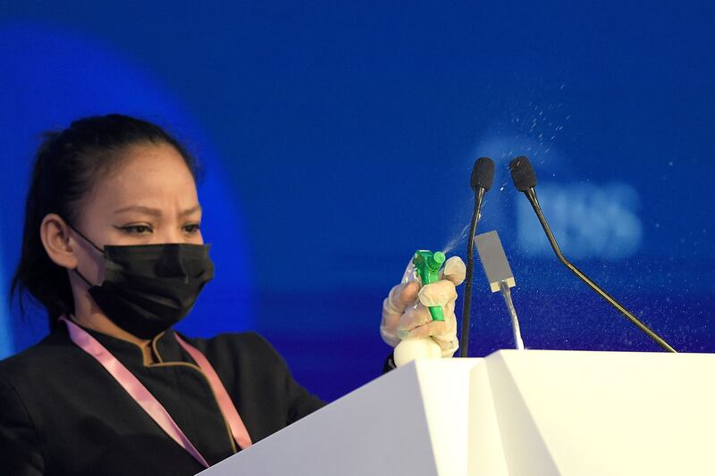 An employee at the event cleans the podium between speeches.