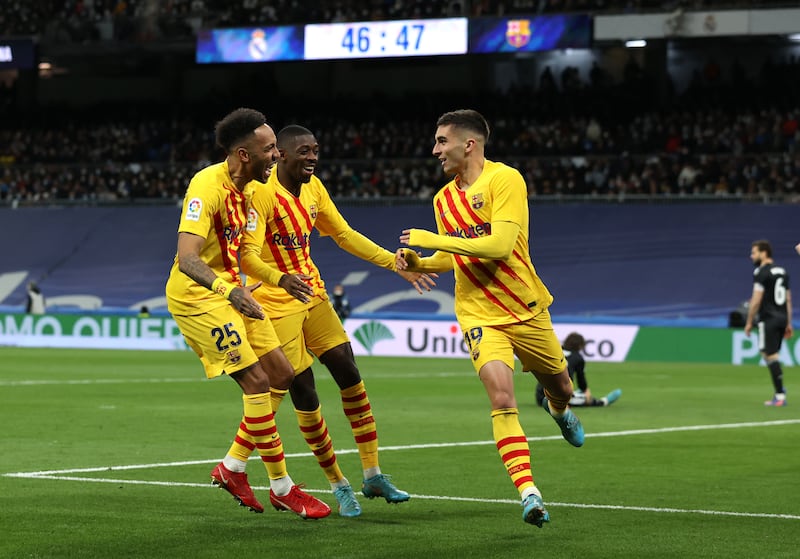 Ferran Torres celebrates with Pierre-Emerick Aubameyang and  Ousmane Dembele after scoring Barcelona's third goal in their 4-0 win against Real Madrid at the Santiago Bernabeu on March 20, 2022. Getty 