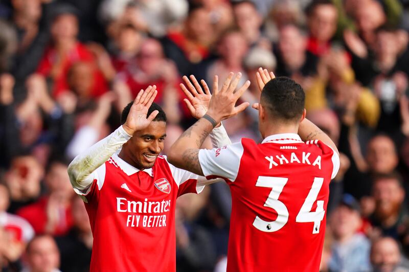 Reiss Nelson celebrates with team-mate Granit Xhaka after scoring Arsenal's third goal. PA