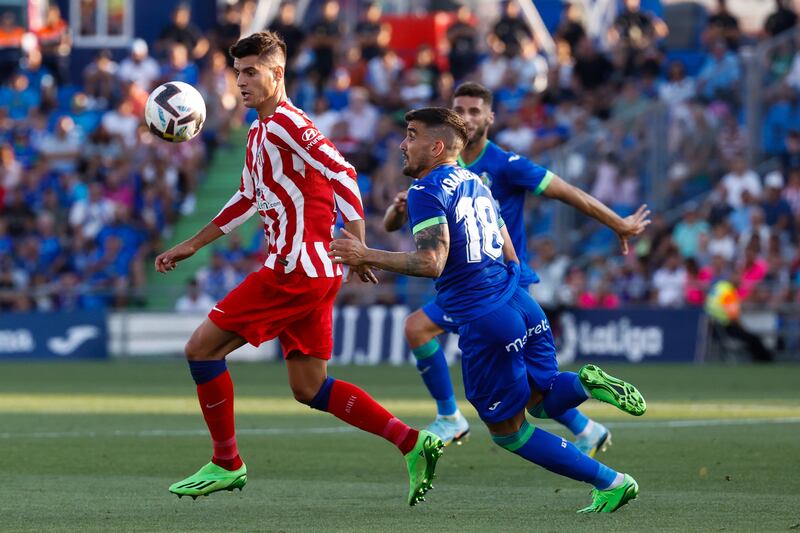 Atletico's Alvaro Morata battles with Getafe midfielder Mauro Arambarri. EPA