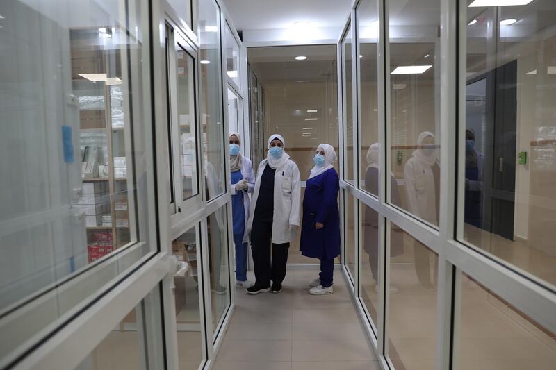 Medical staff walk inside a newly opened Hospital in the west bank city of Nablus. EPA