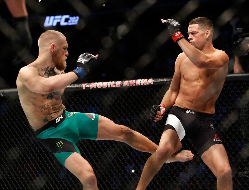 Conor McGregor kicks Nate Diaz during their welterweight rematch at UFC 202 at T-Mobile Arena. AFP
