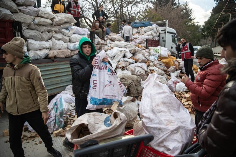 Bags of wood for fires are distributed in Hatay Turkey. Getty