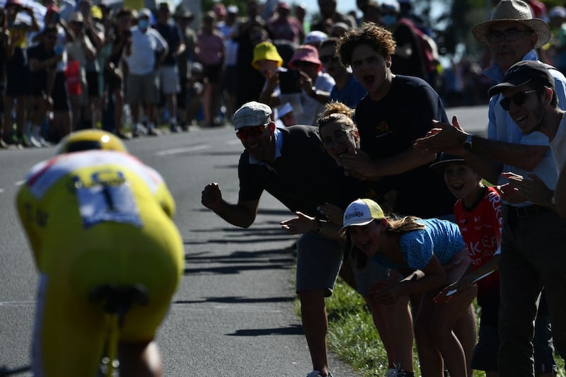 Spectators cheer UAE Emirates' Tadej Pogacar.