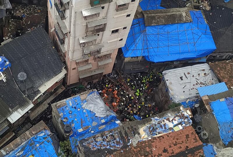 Rescue workers search for survivors at the site of a collapsed building in Mumbai, India. Reuters