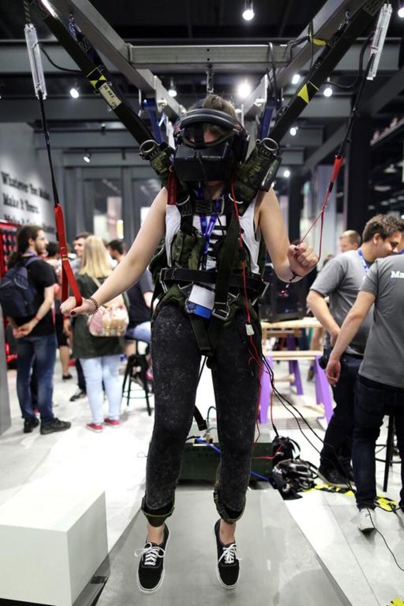 A visitor makes a virtual parachute jump wearing VR goggles at Gamescom. Oliver Berg / EPA