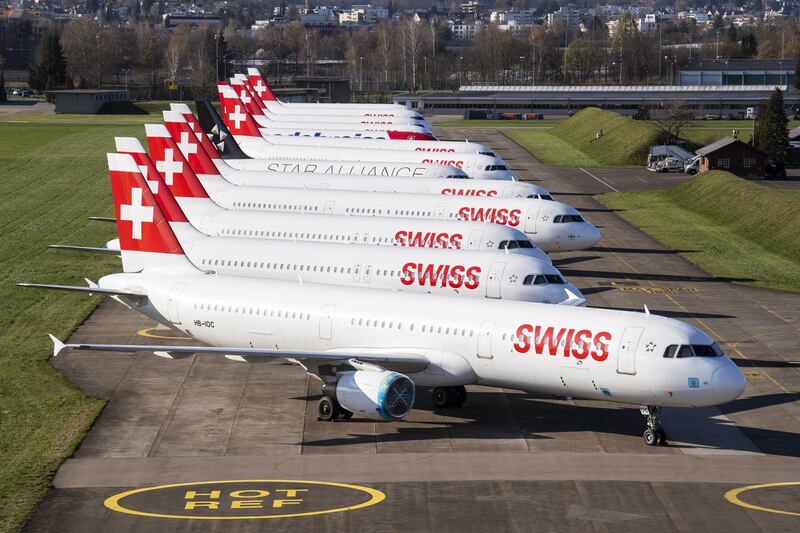 epa08316234 Swiss International Air Lines aircrafts are parked on the tarmac at the airport in Zurich, Switzerland, 23 March 2020. Due to the coronavirus COVID-19 pandemic a large number of flights of the Swiss carrier have been cancelled and a part of their fleet grounding at Zurich airport.  EPA/ENNIO LEANZA