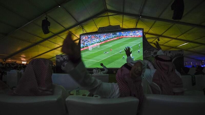 Saudi football supporters react while watching their national team play during their 2018 World Cup in Russia at a fan tent in the Red Sea coastal resort of Jeddah on June 20, 2018. AFP