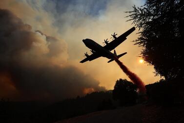 A firefighting plane drops flame retardant ahead of the LNU Lightning Complex fire in Healdsburg, California. Getty Images / AFP