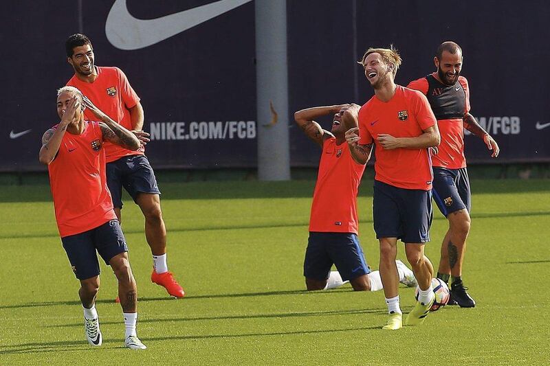 From left to right: Neymar, Luis Suarez, Rafinha, Ivan Rakitic, and Aleix Vidal share a joke. Alejandro Garcia / EPA