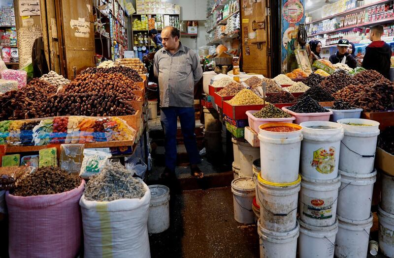 A vendor waits for customers to buy traditional food ahead of the holy fasting month of Ramadan, at the main market in Gaza City. AP Photo