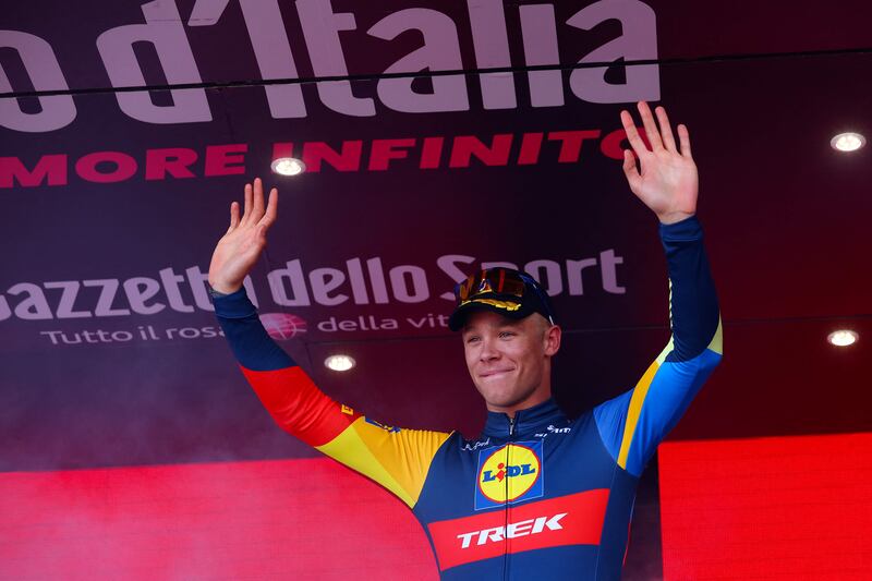 Team Lidl-Trek's Italian rider Jonathan Milan celebrates on the podium after winning the stage. AFP