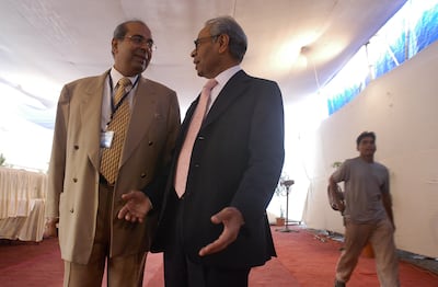 Brothers SP Hinduja and PP Hinduja converse in 2005. Getty Images