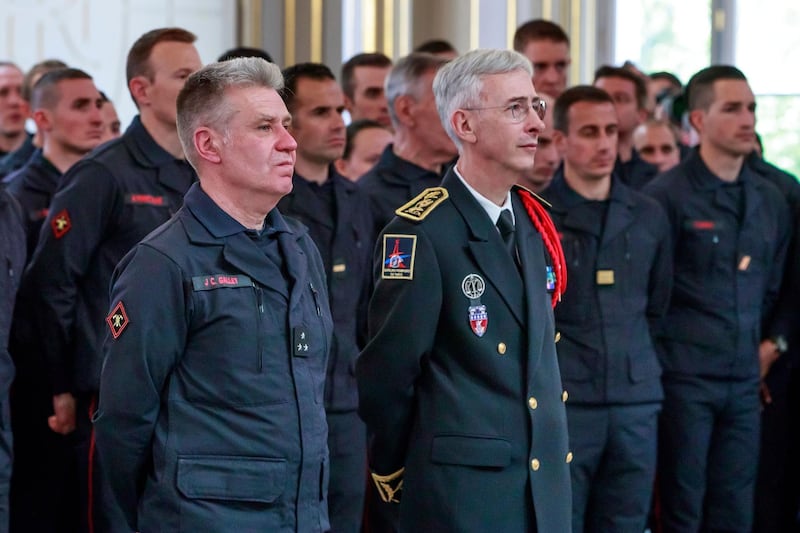 French General Jean-Claude Gallet, left, and Paris Prefect Didier Lallement listen to French President Emmanuel Macron addressing Paris Firefighters' brigade and security forces who took part at the fire extinguishing operations of the Notre Dame of Paris Cathedral fire, at the Elysee Palace in Paris, Thursday, April 18, 2019. France paid a daylong tribute Thursday to the Paris firefighters who saved the internationally revered Notre Dame Cathedral from collapse and rescued many of its treasures. AP