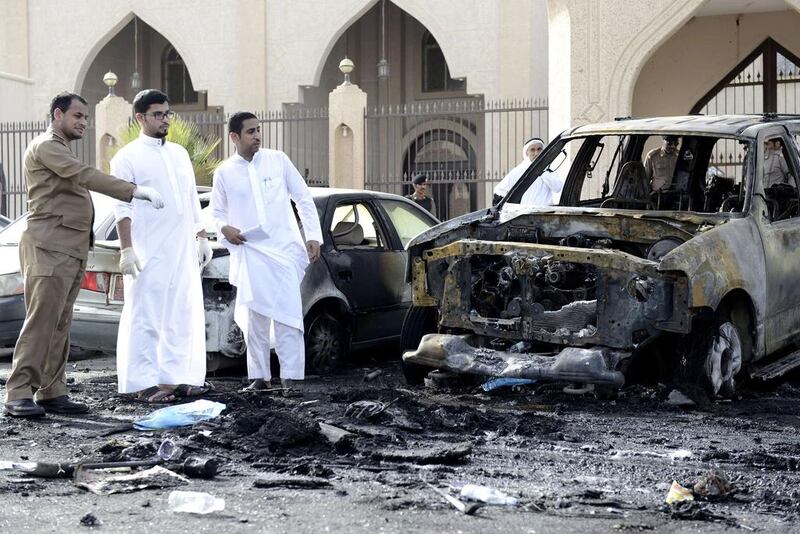 Saudi Arabian security forces and forensic personnel inspect the site of a suicide bombing that targeted the Shiite Al Anoud mosque in the coastal city of Dammam on May 29. AFP Photo

