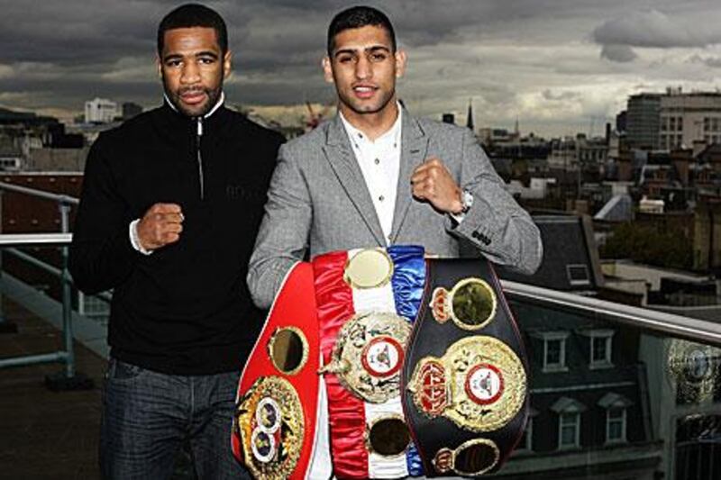Amir Khan, right, puts his titles on the line against Lamont Peterson in Washington DC, the challenger's hometown. Khan wants to push this fight by asking the US president Barack Obama to attend at ringside.