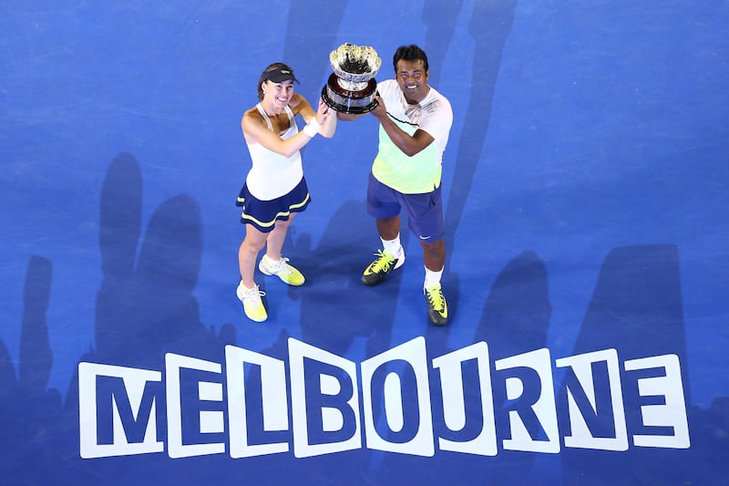 MELBOURNE, AUSTRALIA - FEBRUARY 01:  Martina Hingis of Switzerland and Leander Paes of India hold the winners trophy after their final mixed doubles match against Kristina Mladenovic of France and Daniel Nestor of Canada during day 14 of the 2015 Australian Open at Melbourne Park on February 1, 2015 in Melbourne, Australia.  (Photo by Robert Prezioso/Getty Images)