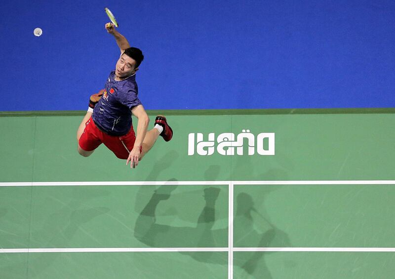 China's Liu Cheng returns the shot to Denmark's Mathias Boe and Carsten Mogensen during the third day of the Dubai Badminton World Superseries Finals in Dubai.  Mahmoud Khaled / AFP Photo