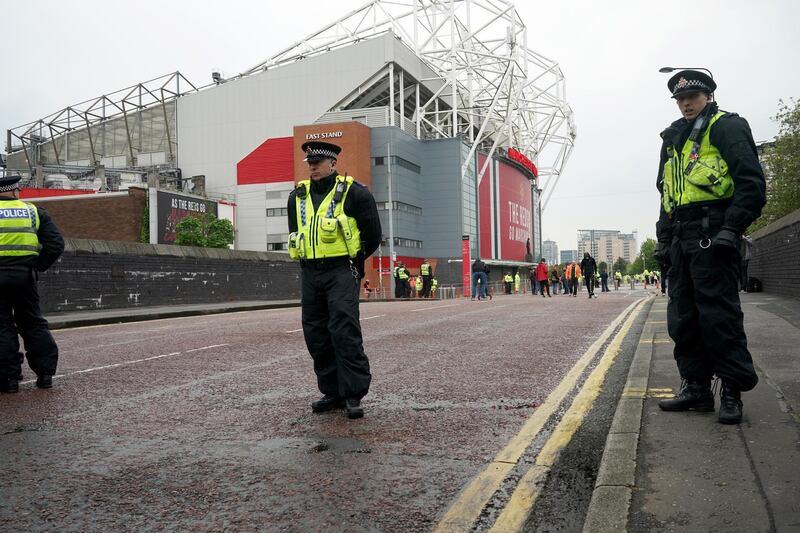 Police and security staff stand guard outside Old Trafford on Thursday. Getty