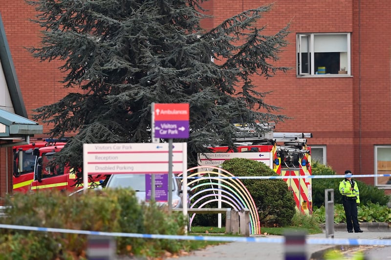 A police officer patrols a cordoned-off area outside the hospital. AFP