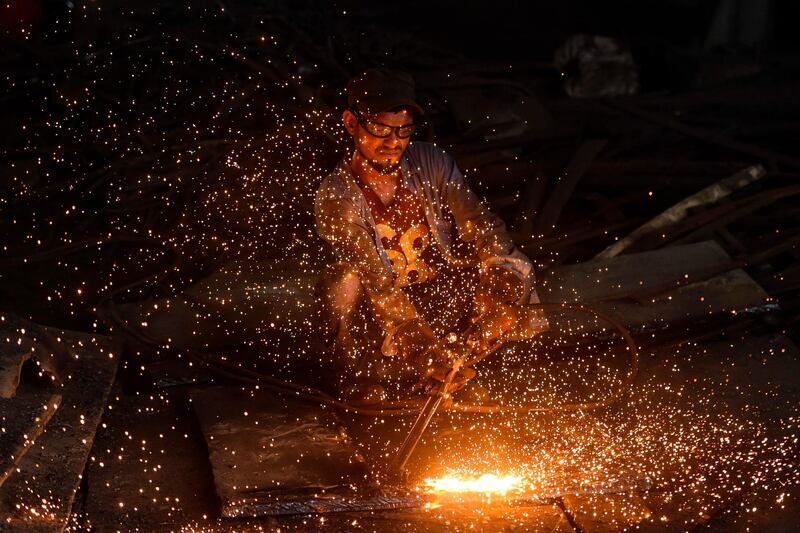 A worker cuts steel sheets at a rolling mill in Narayanganj, on the outskirts of Dhaka.  AFP