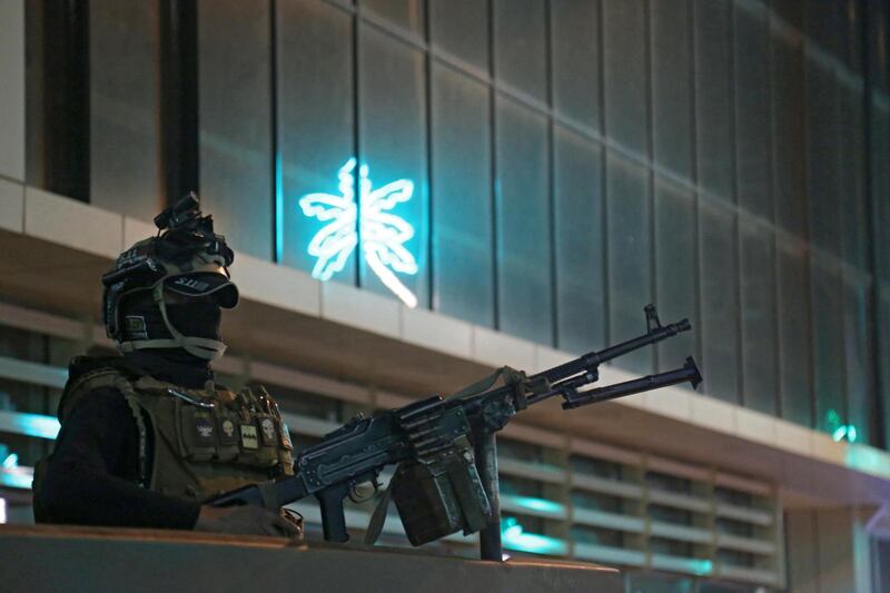 Iraqi police patrol a street in Baghdad during a nightime curfew.  AFP