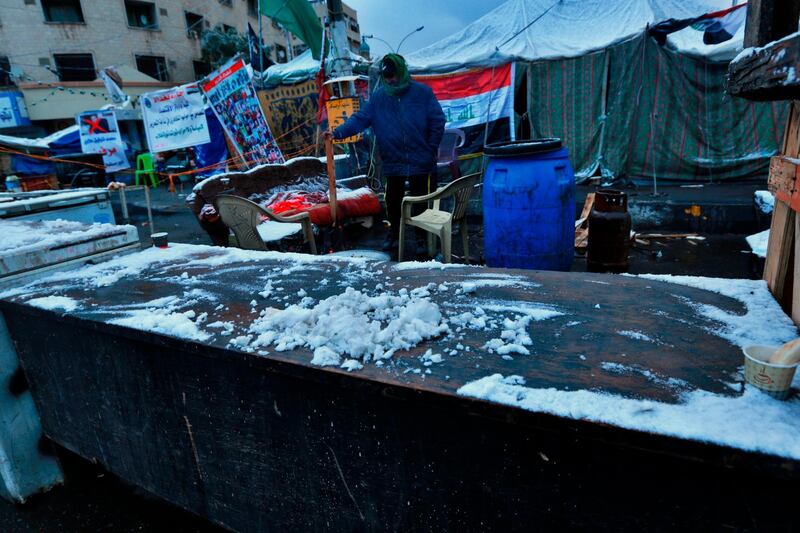 Fresh snow falls in Tahrir Square. AP Photo