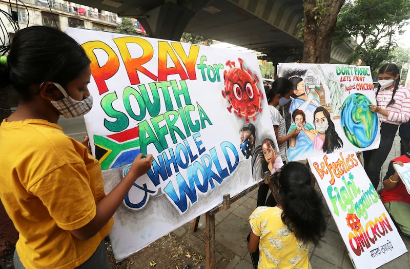 Indian students apply the finishing touches to paintings created to raise awareness of the variant in Mumbai. Reuters