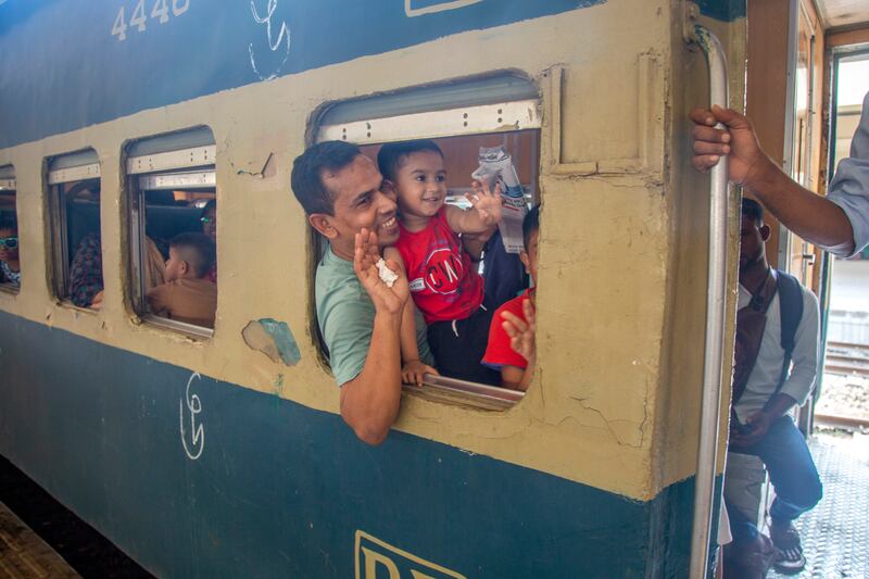 Many Muslims head back to their home towns and villages from bigger cities to spend Eid Al Fitr with family, such as this man and his children leaving Dhaka, Bangladesh. EPA