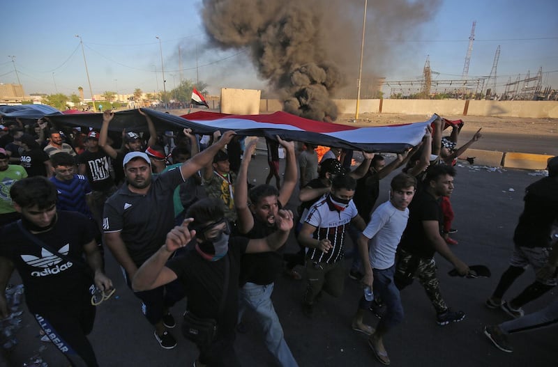 Iraqi protesters take part in a demonstration against state corruption, failing public services, and unemployment, in the Iraqi capital Baghdad's central Khellani Square. AFP