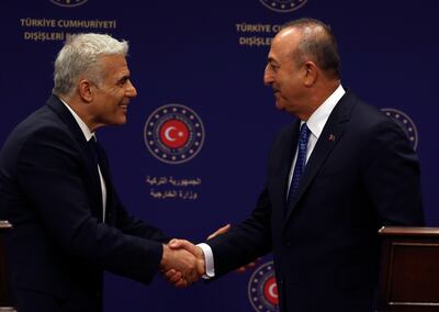 Turkish Foreign Minister Mevlut Cavusoglu, right, and Israeli Foreign Minister Yair Lapid after a press conference in Ankara on Thursday. AP 