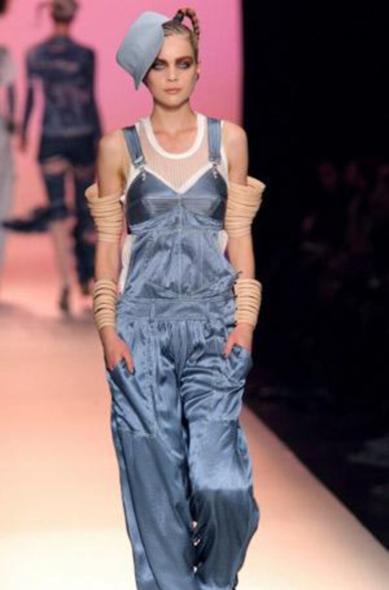 A model presents a 1980s-style dungarees outfit by French designer Jean Paul Gaultier.