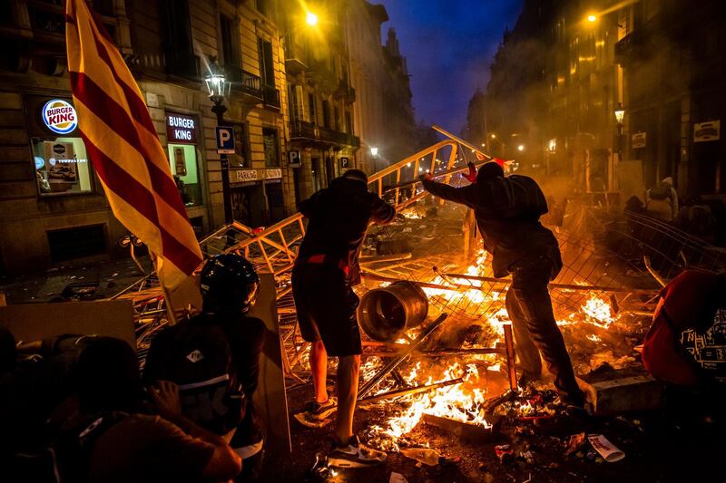 Protesters start a fire as they clash with riot police during a demonstration in Barcelona, Spain, on Friday, Oct. 18, 2019. The scale and violence of Catalan protests this week could present a severe challenge to Prime Minister Pedro Sanchez as he prepares to lead his Socialist party into the elections, the fourth national poll in as many years. Bloomberg