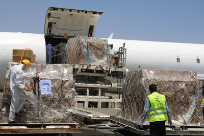 In this Wednesday, June 17, 2020, workers unload boxes of medical supplies on arrival at Sanaa International Airport in Sanaa, Yemen. The shipment includes ventilators, coronavirus test kits, PCR machines and personal protective equipment. Organized by the United Nations and private companies, it comes as the UN is facing a funding shortage for its operations in the war-torn country, where officials and medical experts fear the coronavirus could be spreading unchecked due to limited medical facilities. (World Health Organization via AP)