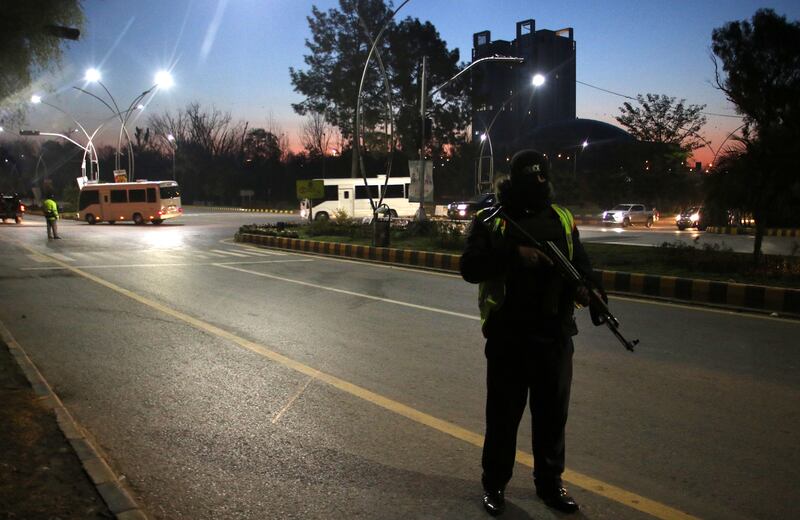 Security officials stand guard as the Australian cricket team arrives in Pakistan. EPA