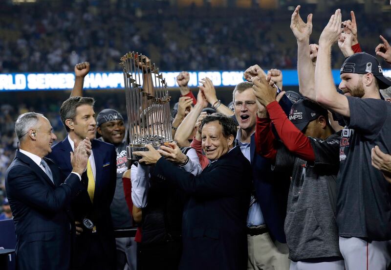 Boston Red Sox chairman Tom Werner holds the championship trophy. AP Photo