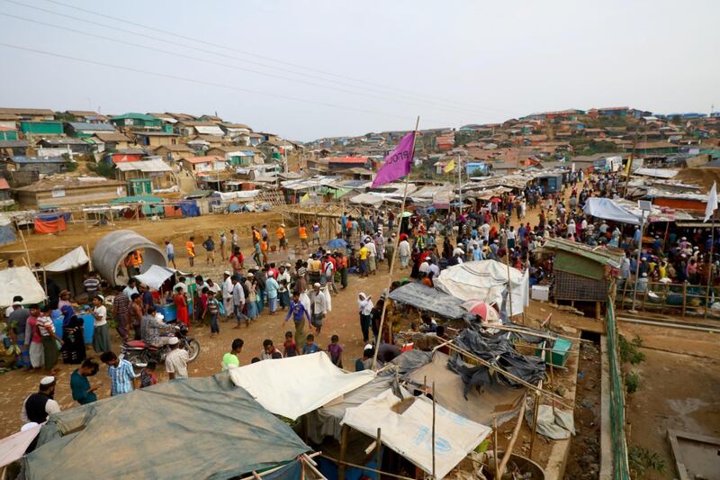 FILE PHOTO: Rohingya refugees gather at a market inside a refugee camp in Cox's Bazar, Bangladesh, March 7, 2019. REUTERS/Mohammad Ponir Hossain/File Photo
