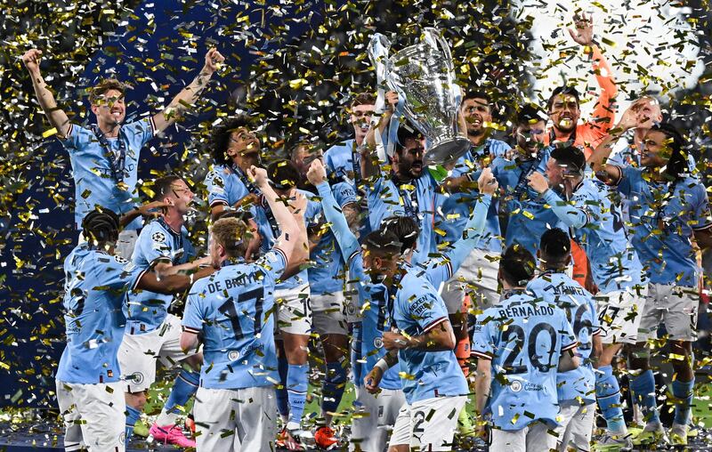 Manchester City's German midfielder #8 Ilkay Gundogan holds aloft the European Cup trophy as they celebrate winning the UEFA Champions League final football match between Inter Milan and Manchester City at the Ataturk Olympic Stadium in Istanbul. AFP