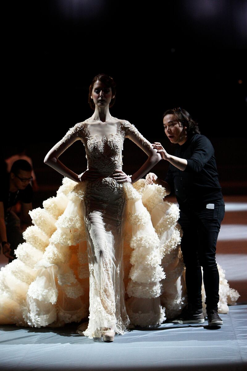 DUBAI , UNITED ARAB EMIRATES Ð April 27 , 2013 : Michael Cinco , fashion designer ( right ) with model during the rehearsal before the start of his show at Madinat Jumeirah in Dubai. ( Pawan Singh / The National ) For Arts & Life. Story by James Gabrillo

