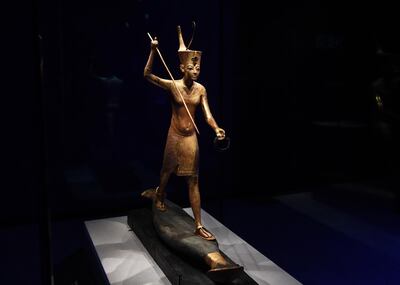 epa07964552 A gilded wooden figure of Tutankhamun throwing a harpoon, dated 1336-1326 BC is seeing during the press preview for the 'Tutankhamun: Treasures of the Golden Phaorah' exhibition at the Saatchi Gallery in Chelsea in London, Britain, 01 November 2019.  EPA/FACUNDO ARRIZABALAGA