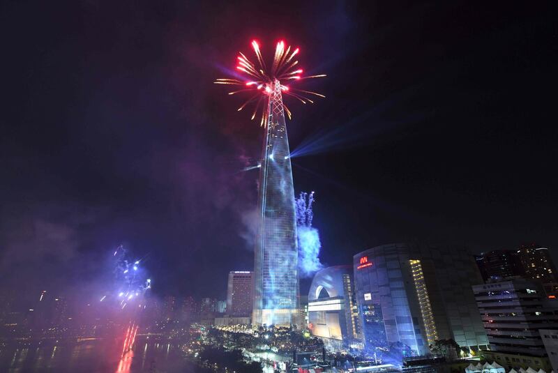 Fireworks light the sky over the Lotte World Tower, a 123-floor and 1,821-foot building, after midnight during a countdown event to celebrate the New Year in Seoul, South Korea. Jung Yeon-Je / AFP